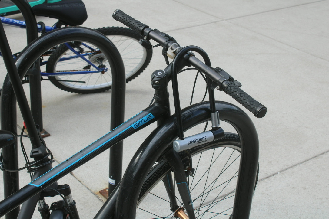 a bike with the lock hanging off the handlebar, not attached to anything