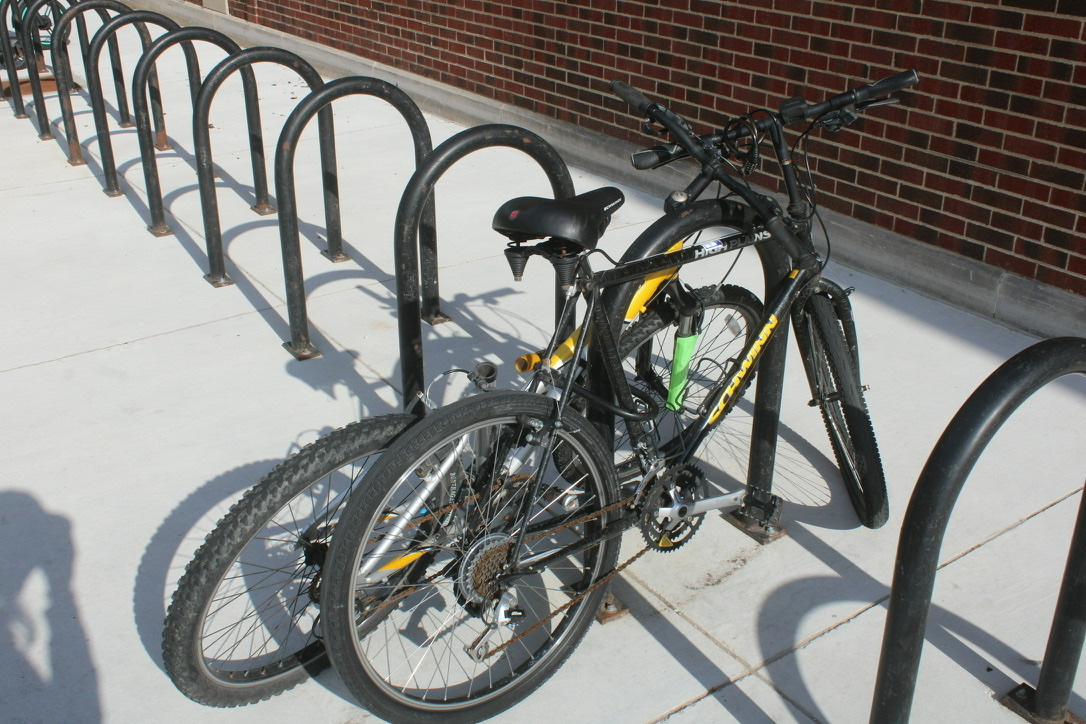 two bikes, leaning on each other, sharing a single lock around both chassis