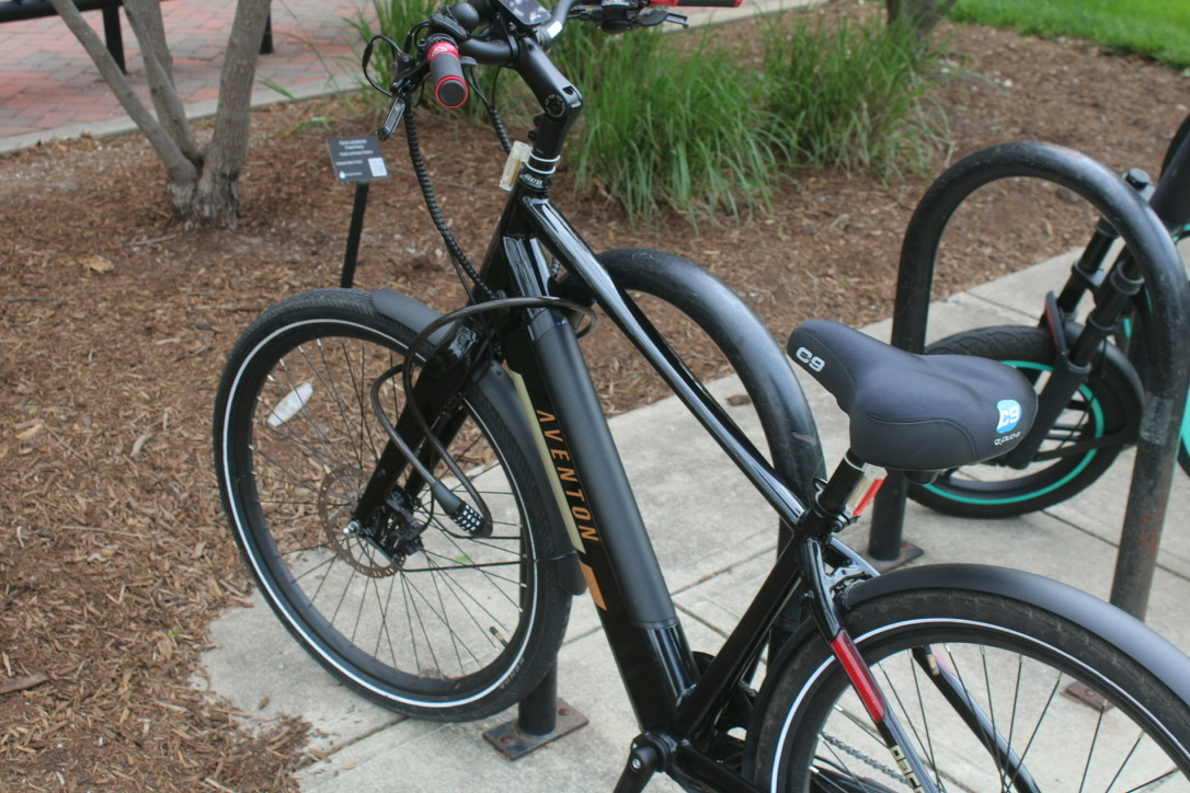 an ebike with a cable lock through the front wheel and chassis