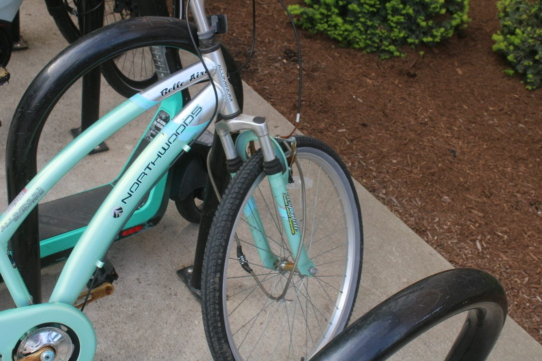 an older bike with a cable lock locked through the front wheel spokes